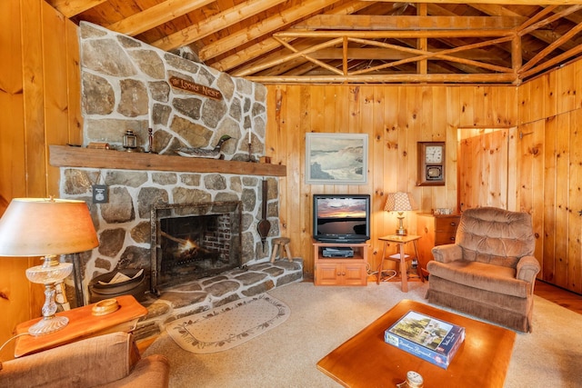 living area featuring wooden ceiling, a fireplace, wooden walls, and carpet floors
