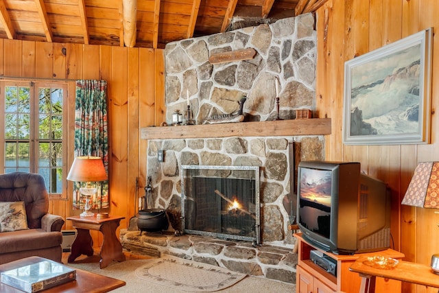 living area with wood ceiling, wood walls, beamed ceiling, a fireplace, and baseboard heating