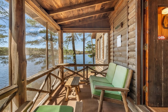 sunroom / solarium featuring a water view and plenty of natural light