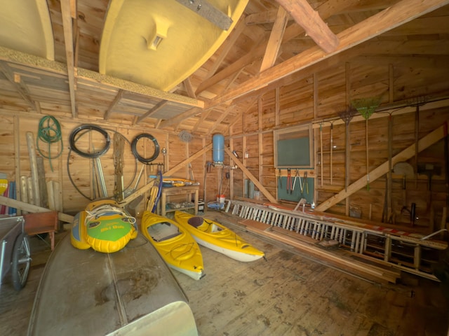 miscellaneous room featuring vaulted ceiling and a garage