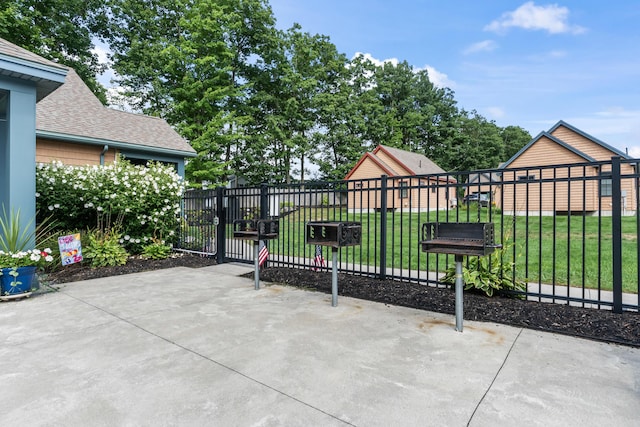 view of gate featuring a lawn and fence