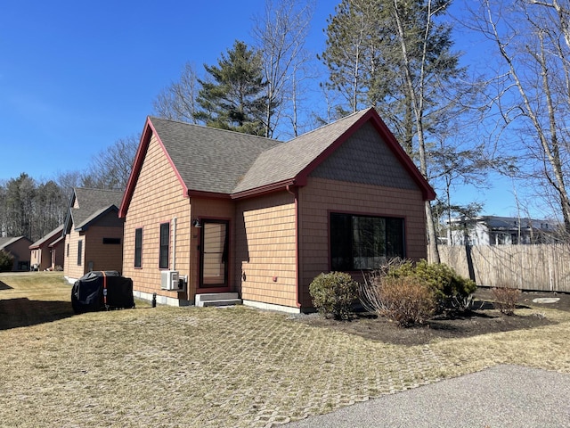 view of front of home featuring entry steps, fence, cooling unit, and roof with shingles