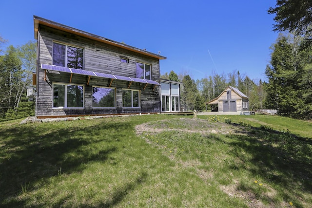 1300 Belfast Rd, Knox, ME 04986 - rear view of house featuring a garage, an outdoor structure, and a lawn