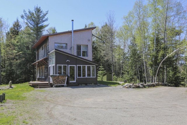 1300 Belfast Rd, Knox, ME 04986 - back of house with an outdoor structure, a storage unit, and dirt driveway