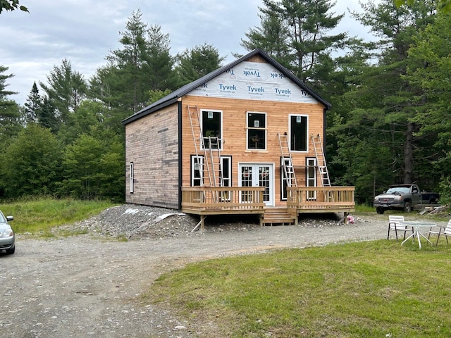 view of front of property with a front yard and a deck