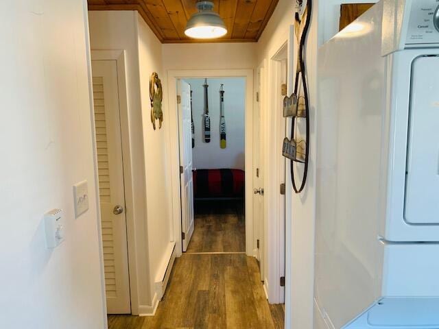 corridor with washer / clothes dryer, wood finished floors, wooden ceiling, and a baseboard radiator