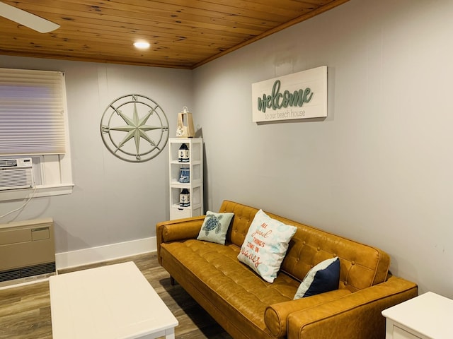 living area featuring cooling unit, wooden ceiling, baseboards, a ceiling fan, and wood finished floors
