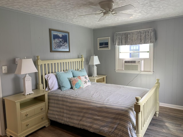 bedroom with cooling unit, baseboards, ceiling fan, and wood finished floors