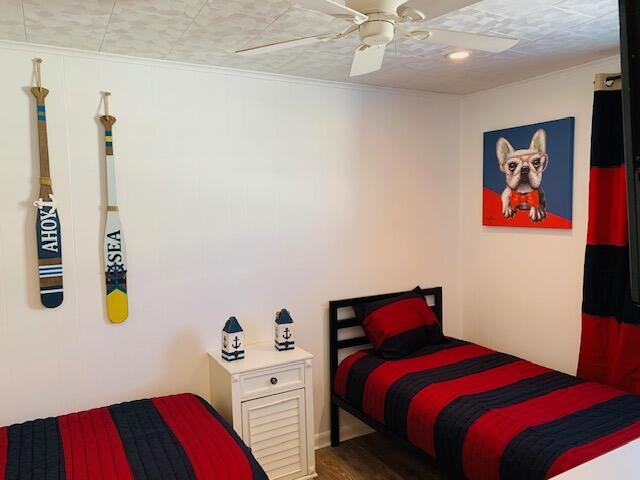 bedroom with wood finished floors and a ceiling fan