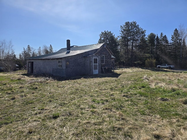 292 Forest City Rd, Brookton Twp, ME 04413 - view of property exterior with metal roof and a chimney