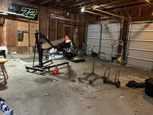 garage with wooden walls and a garage door opener