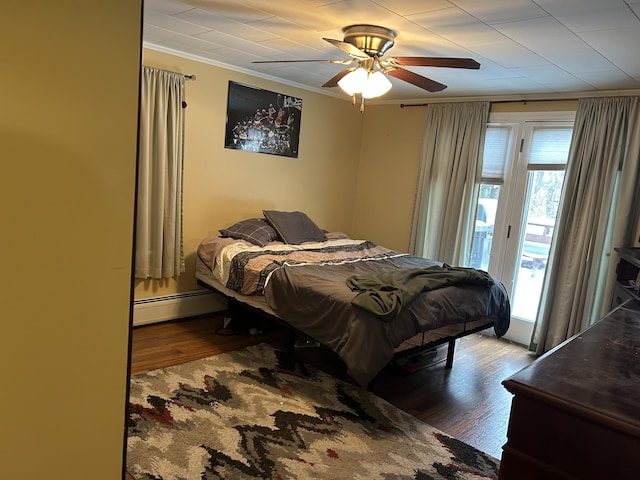 bedroom featuring ornamental molding, wood finished floors, baseboard heating, access to outside, and a ceiling fan