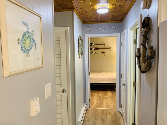 542 Ocean Ave, Wells, ME 04090 - corridor featuring wood finished floors, wooden ceiling, and a baseboard heating unit
