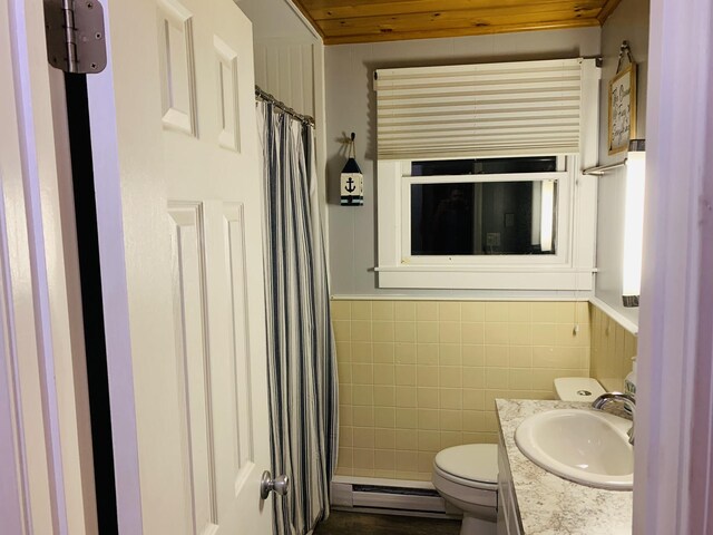 542 Ocean Ave, Wells, ME 04090 - full bathroom featuring tile walls, toilet, vanity, baseboard heating, and wainscoting