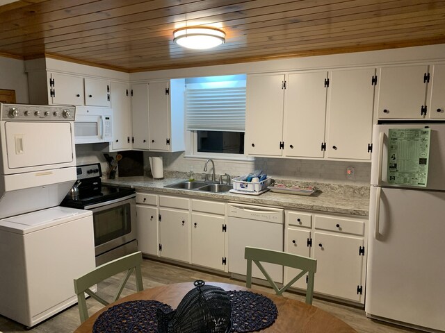 542 Ocean Ave, Wells, ME 04090 - kitchen with light countertops, wood ceiling, a sink, stacked washing maching and dryer, and white appliances