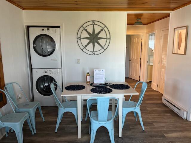 542 Ocean Ave, Wells, ME 04090 - dining area with wood ceiling, dark wood-style flooring, stacked washer and dryer, and a baseboard heating unit