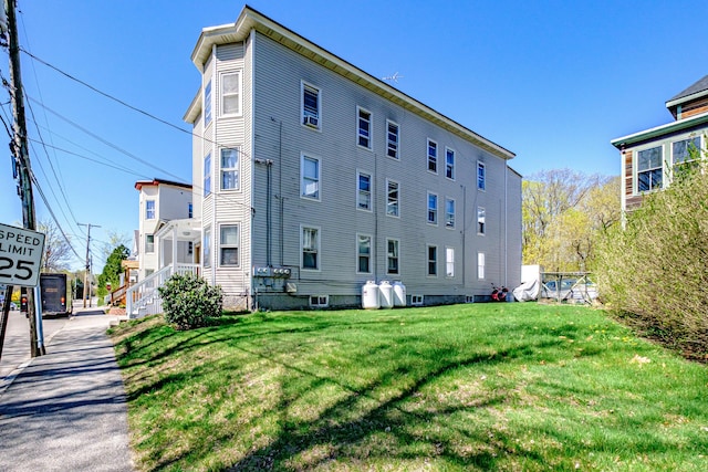 view of side of property with a lawn