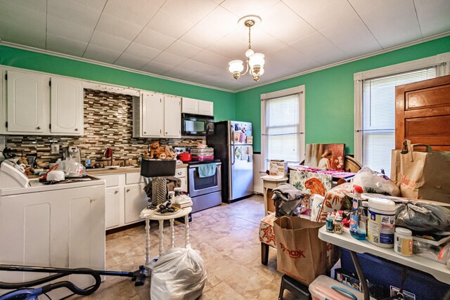 kitchen with stainless steel appliances, white cabinets, ornamental molding, washer / clothes dryer, and backsplash