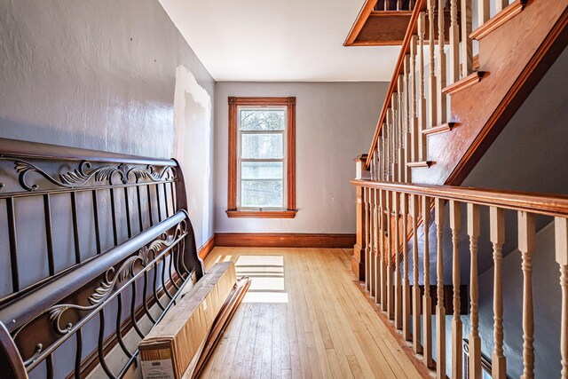 staircase with wood-type flooring and baseboards