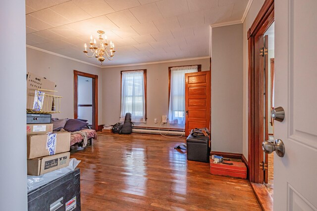 miscellaneous room featuring ornamental molding, wood-type flooring, a chandelier, and baseboard heating