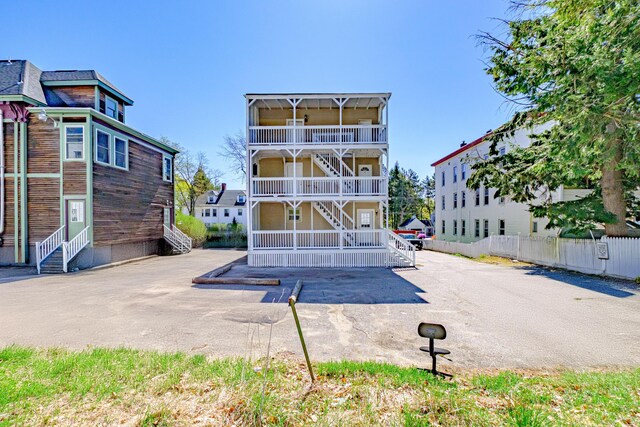 exterior space with stairway, entry steps, and fence