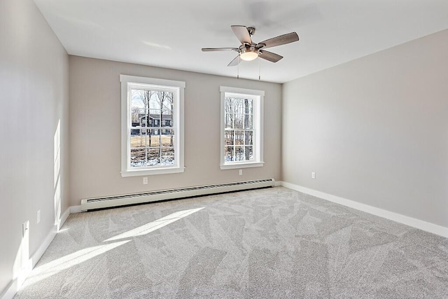 unfurnished room with carpet floors, baseboards, a baseboard heating unit, and a ceiling fan