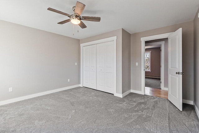unfurnished bedroom featuring a closet, a baseboard radiator, baseboards, ceiling fan, and carpet