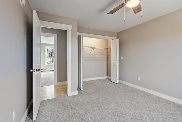 unfurnished bedroom with light colored carpet, a closet, baseboards, and a ceiling fan