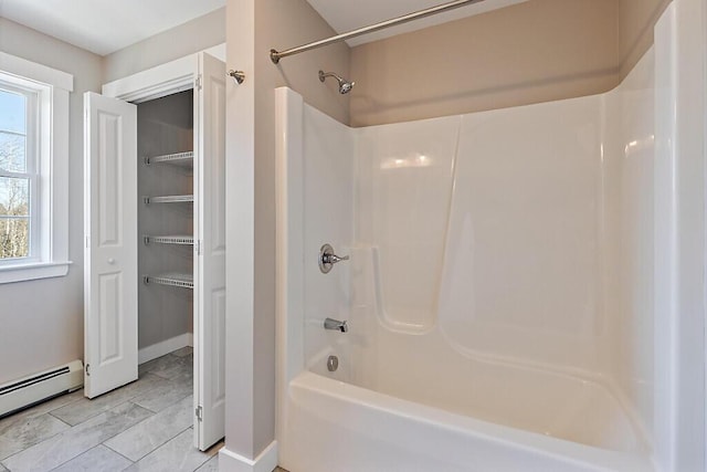 bathroom featuring a baseboard radiator and shower / bathtub combination