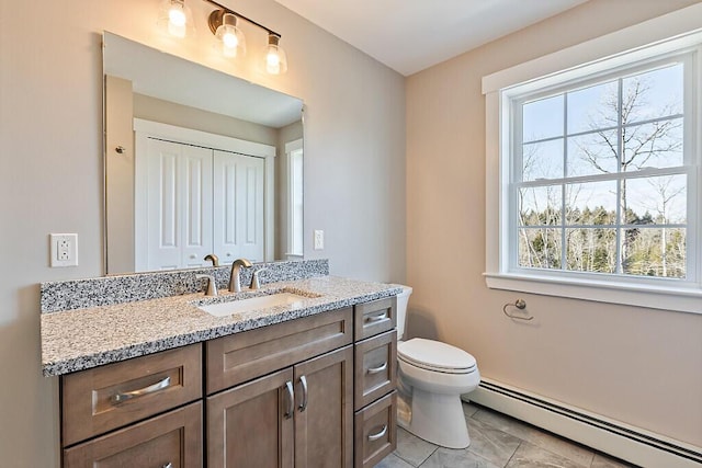 bathroom with a baseboard radiator, toilet, and vanity