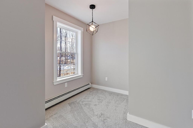 spare room with carpet, baseboards, and baseboard heating