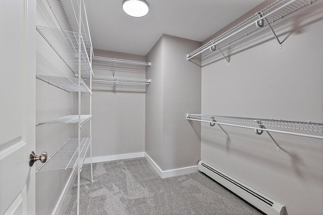spacious closet with carpet floors and a baseboard heating unit