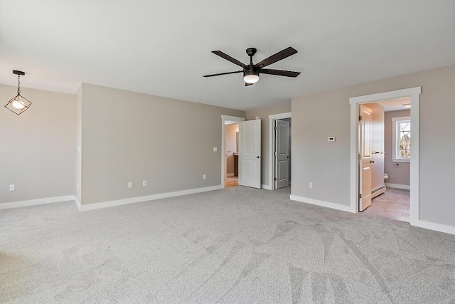 unfurnished bedroom with light colored carpet, ensuite bath, ceiling fan, and baseboards