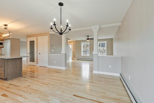kitchen featuring open floor plan, light stone countertops, a baseboard heating unit, and light wood finished floors