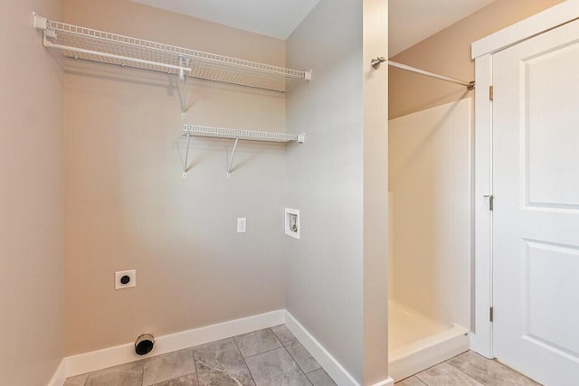 washroom featuring baseboards, laundry area, hookup for an electric dryer, and hookup for a washing machine