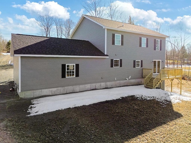 back of property featuring a deck and stairway
