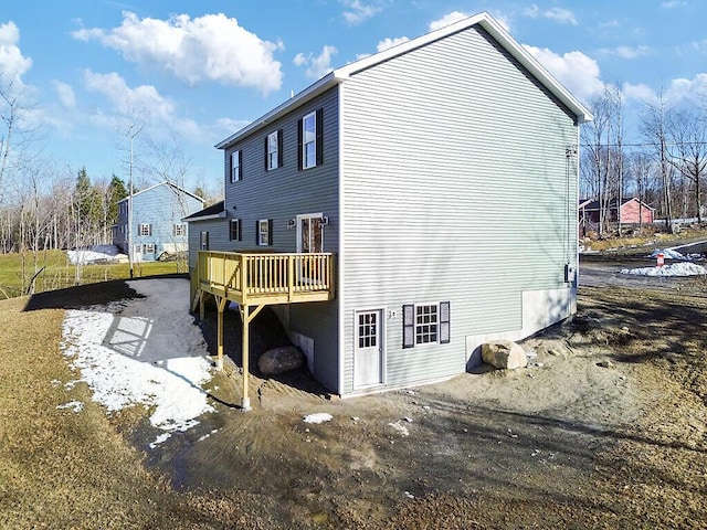 back of property with a wooden deck