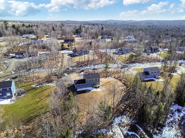 birds eye view of property featuring a wooded view