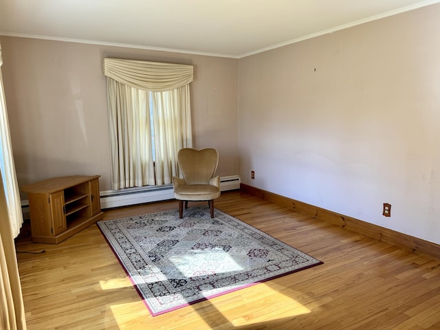 living area featuring a baseboard heating unit, baseboards, crown molding, and light wood-type flooring