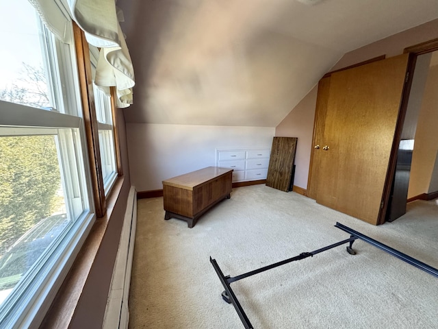 bedroom featuring multiple windows, vaulted ceiling, baseboards, and light carpet
