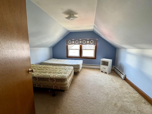 carpeted bedroom with a baseboard heating unit, vaulted ceiling, baseboards, and baseboard heating