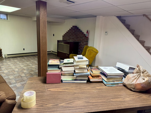office featuring baseboard heating, a baseboard radiator, and a drop ceiling