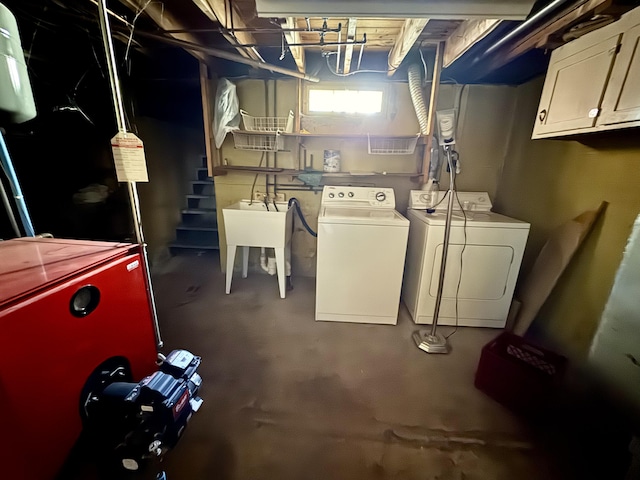 below grade area featuring washing machine and clothes dryer and a sink