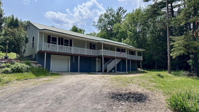 81 Maple Ridge Rd, Harrison, ME 04040 - view of front of home featuring dirt driveway, a garage, stairway, and metal roof