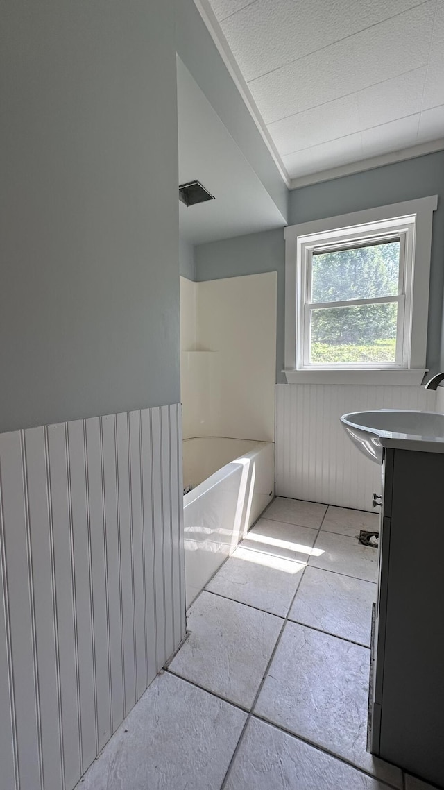 81 Maple Ridge Rd, Harrison, ME 04040 - full bathroom featuring vanity, a bath, and a wainscoted wall