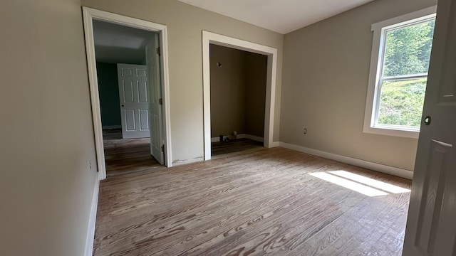 81 Maple Ridge Rd, Harrison, ME 04040 - unfurnished bedroom featuring wood finished floors, multiple windows, and baseboards