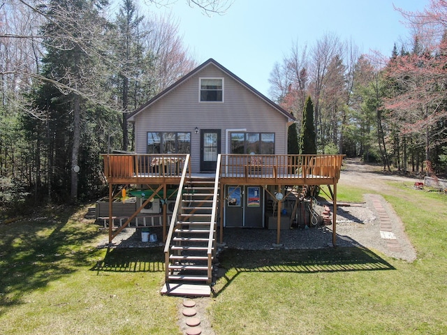 rear view of house featuring a yard, a deck, and stairs