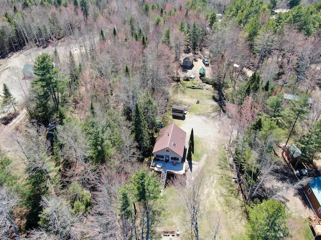 drone / aerial view featuring a wooded view