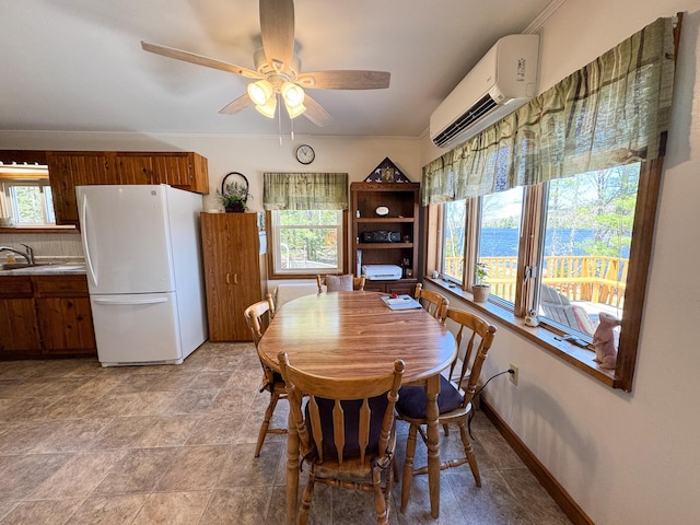 dining space with plenty of natural light, a wall unit AC, and ceiling fan