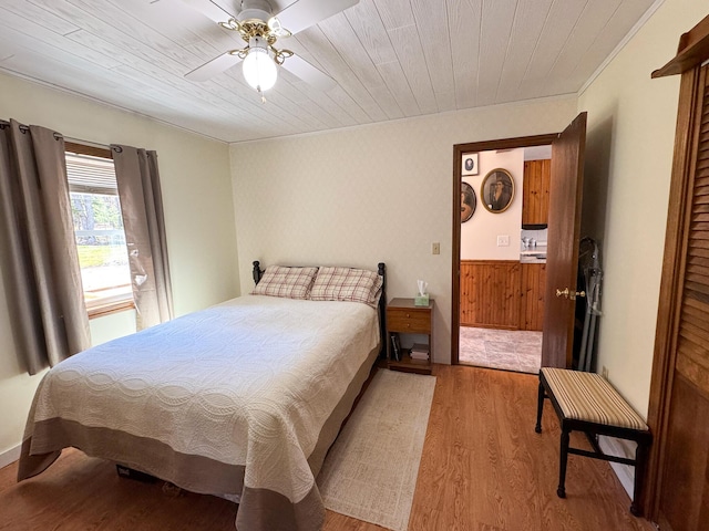 bedroom featuring crown molding, wooden ceiling, ceiling fan, and wood finished floors